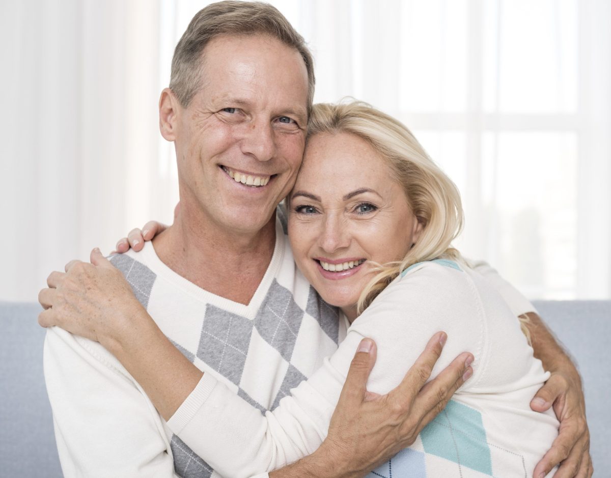 medium-shot-happy-couple-hugging-indoors